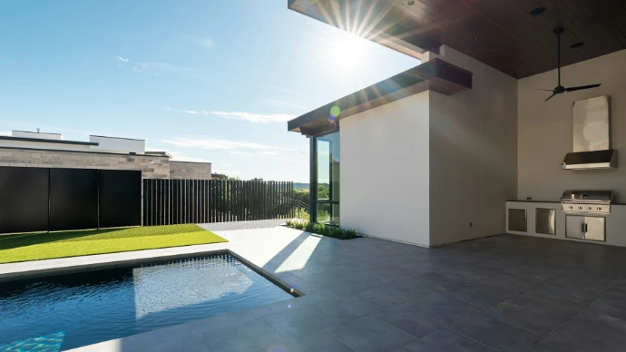 Modern outdoor patio with a swimming pool and outdoor kitchen